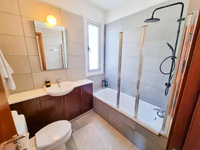 a bathroom with a toilet and a sink and a shower at Poser Beach Villa With Private Pool And BBQ in Pervolia