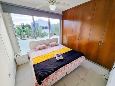 a bedroom with a bed and a large window at Poser Beach Villa With Private Pool And BBQ in Pervolia