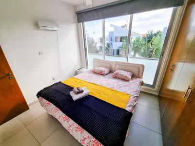 a bedroom with a bed with two towels on it at Poser Beach Villa With Private Pool And BBQ in Pervolia