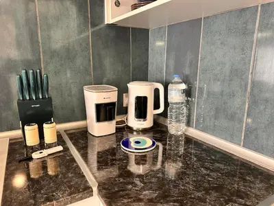 a kitchen counter with two coffee makers and a bottle of water at Flat in Kyrenia, Cyprus in Kérynia