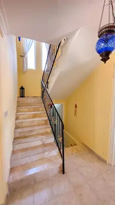 a staircase in a home with a chandelier at Villa NATURA in Strovolos