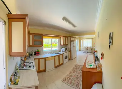 a kitchen with a sink and a stove top oven at Villa NATURA in Strovolos