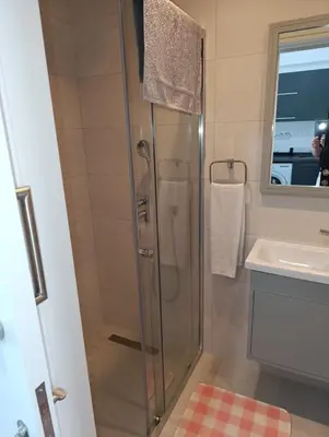 a bathroom with a shower and a sink at Deja Blue Apartments, North Cyprus
