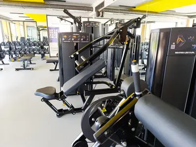 a gym with rows of treadmills and machines at Deja Blue Apartments, North Cyprus