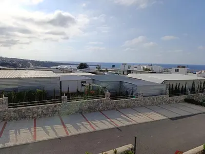 a row of buildings with the ocean in the background at Deja Blue Apartments, North Cyprus