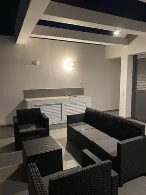 a living room with couches and a table and chairs at Mall View Modern PentHouse in Larnaka