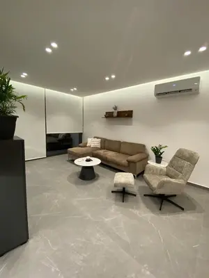 a living room with a couch and two chairs and a table at Mall View Modern PentHouse in Larnaka