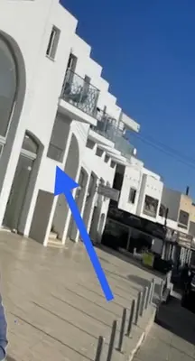 a blue arrow on the side of a building at Bachelor Court 1 in Ayia Napa