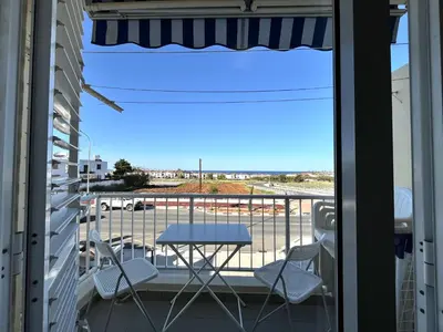a balcony with a table and chairs and a view of a street at STAY Almyra House in Protaras