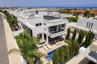 an aerial view of a white house with a swimming pool at Levanda Hills Haven in Protaras in Paralimni