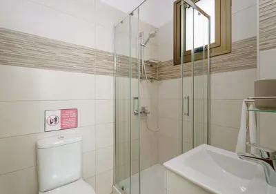 a bathroom with a shower and a toilet and a sink at Levanda Dreams 8 in Paralimni