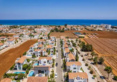 an aerial view of a village with houses and the ocean at Levanda Dreams 8 in Paralimni
