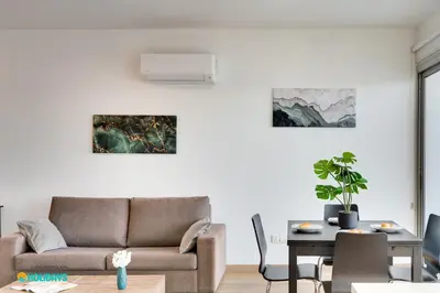 a living room with a couch and a table at The lighthouse 1 bedroom 604 in Larnaka