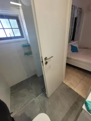 a bathroom with a toilet and a window at Ayia Napa Marina Luxury Villas - Aquamarine in Ayia Napa
