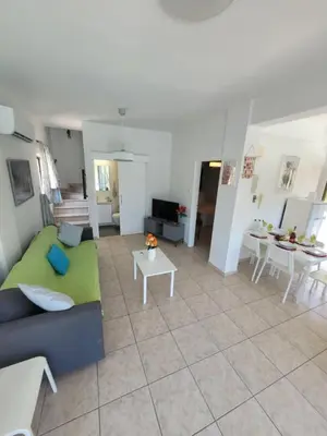 a living room with a couch and a table at Ayia Napa Marina Luxury Villas - Aquamarine in Ayia Napa