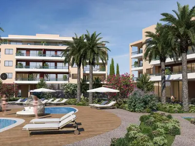 a resort with lounge chairs and a pool and a building at Sanders Limassol Park - Full Building in Trakhoni