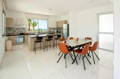 a kitchen with a table and chairs in a room at Elite Panoramic View 3Bdr Villa with pool Ayia Napa in Ayia Napa