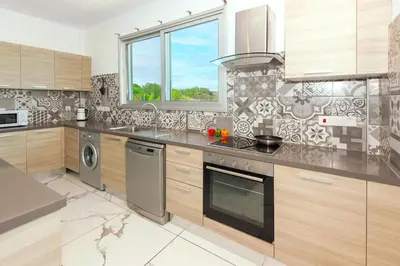 a kitchen with a stove and a dishwasher at Royal Panoramic View 3Bdr Villa with pool Ayia Napa in Ayia Napa