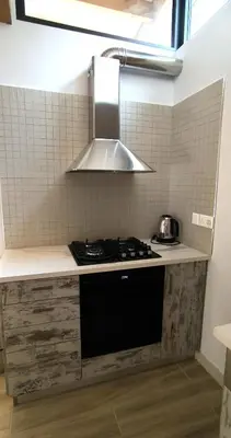 a kitchen with a sink and a stove top oven at The Zephyr House in Pyrgos