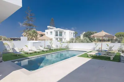 a swimming pool with chairs and a villa at Ayia Napa Orea Villa OR9 in Ayia Napa