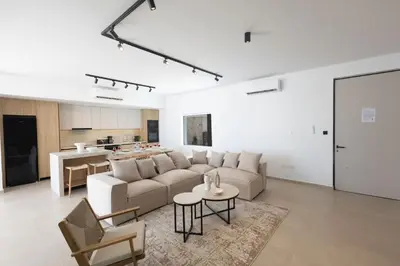 a living room with a couch and a table at Ayia Napa Orea Villa OR9 in Ayia Napa