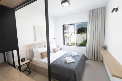 a hotel room with a bed and a window at Ayia Napa Orea Villa OR9 in Ayia Napa