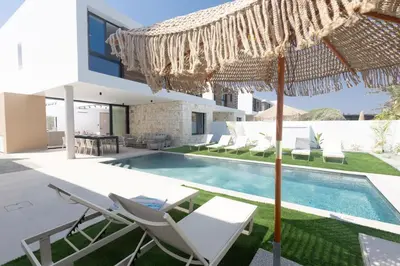 an external view of a villa with a swimming pool at Ayia Napa Orea Villa OR9 in Ayia Napa