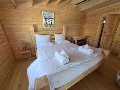 a bedroom with a large bed in a log cabin at Kellaki Relaxation Cottage in Kellaki