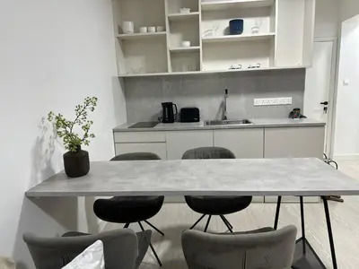 a kitchen with a large table and chairs at Modern City Apartment in Larnaka