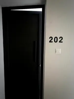 a black elevator door with the number twenty two at The Minimal Nest in Nicosia