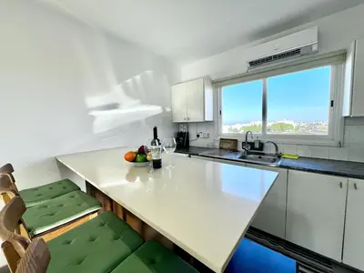 a kitchen with a white counter and a window at STAY Capari Light Apartment in Protaras