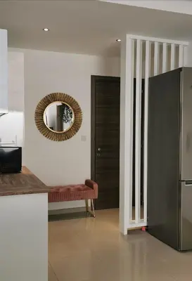 a living room with a mirror and a couch at Nestia Apartment in Yermasoyia