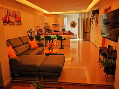a living room with a couch and a table at Nestia Apartment in Yermasoyia