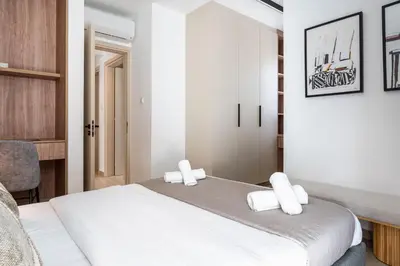 a bedroom with a large white bed with white pillows at Densho 2-Bedroom Luxury Apartment in Larnaka