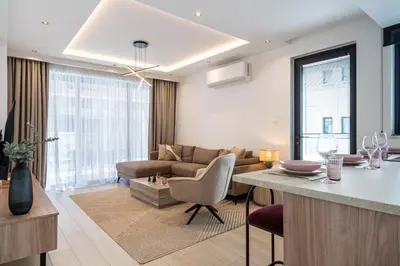 a kitchen and living room with a couch and a table at Densho 2-Bedroom Luxury Apartment in Larnaka