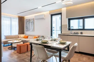 a kitchen and living room with a table and chairs at Itero 2-Bedroom Luxury Apartment in Larnaka