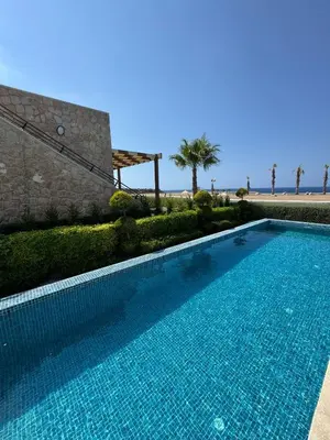a swimming pool in front of a building at Mykonos Homes Villa in Aglantzia