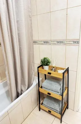 a bathroom with a bathtub and a table with towels at Stay in Harmony in Paralimni