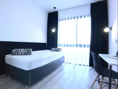 a bedroom with a bed and a desk and a window at Eden Garden 2 bedroom Alsancak in Nicosia International Airport