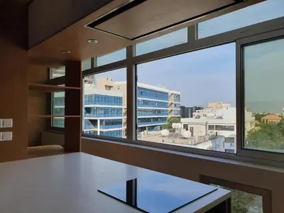 a room with windows and a table with a view at The C Suite - Business & Leisure in Nicosia in Nicosia
