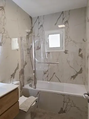 a bathroom with a shower and a tub and a sink at Brand new sea view walking distance to the sea 200m in Limassol