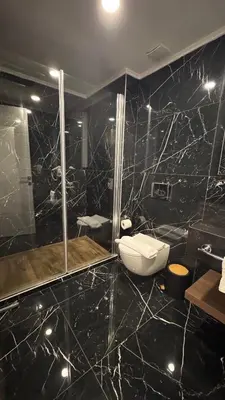 a black bathroom with a toilet and a shower at Long Beach, İskele, Grand Sapphire Resort - Pool View Luxury Studio in Paralimni