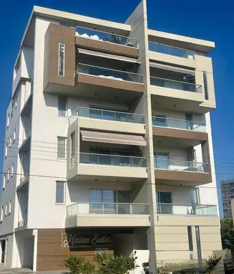 a tall white apartment building with balconies at Mariam Court 302 in Larnaka