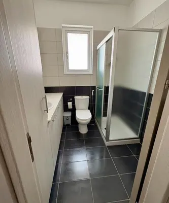 a bathroom with a toilet and a glass shower at Mariam Court 302 in Larnaka
