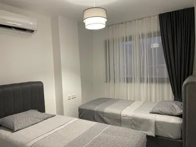 a bedroom with two beds and a window at Penthouse Blueberry North Cyprus in Kérynia