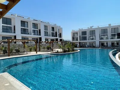 a large swimming pool in front of a building at Penthouse Blueberry North Cyprus in Kérynia