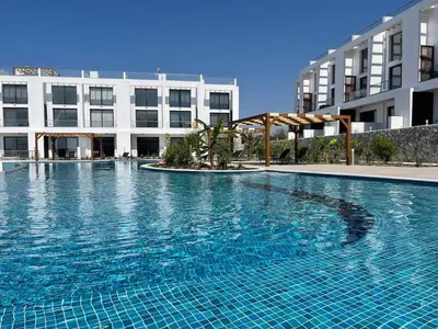 a large swimming pool in front of a building at Penthouse Blueberry North Cyprus in Kérynia