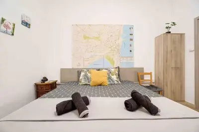 a bedroom with a bed with two brown towels on it at Сozy and traditional - EC Studios in Larnaka