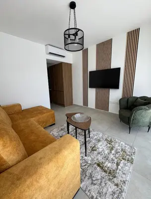 a living room with a couch and a tv at Modern Seaside Studio at Northern Cyprus - Pearl Island in Pyla