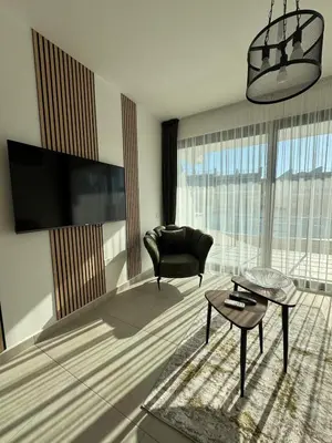 a living room with a chair and a table at Modern Seaside Studio at Northern Cyprus - Pearl Island in Pyla